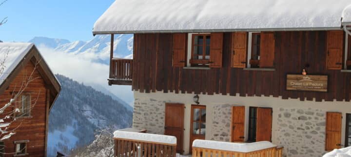 Chalet exterior with traditional wood shutters and panoramic mountain views