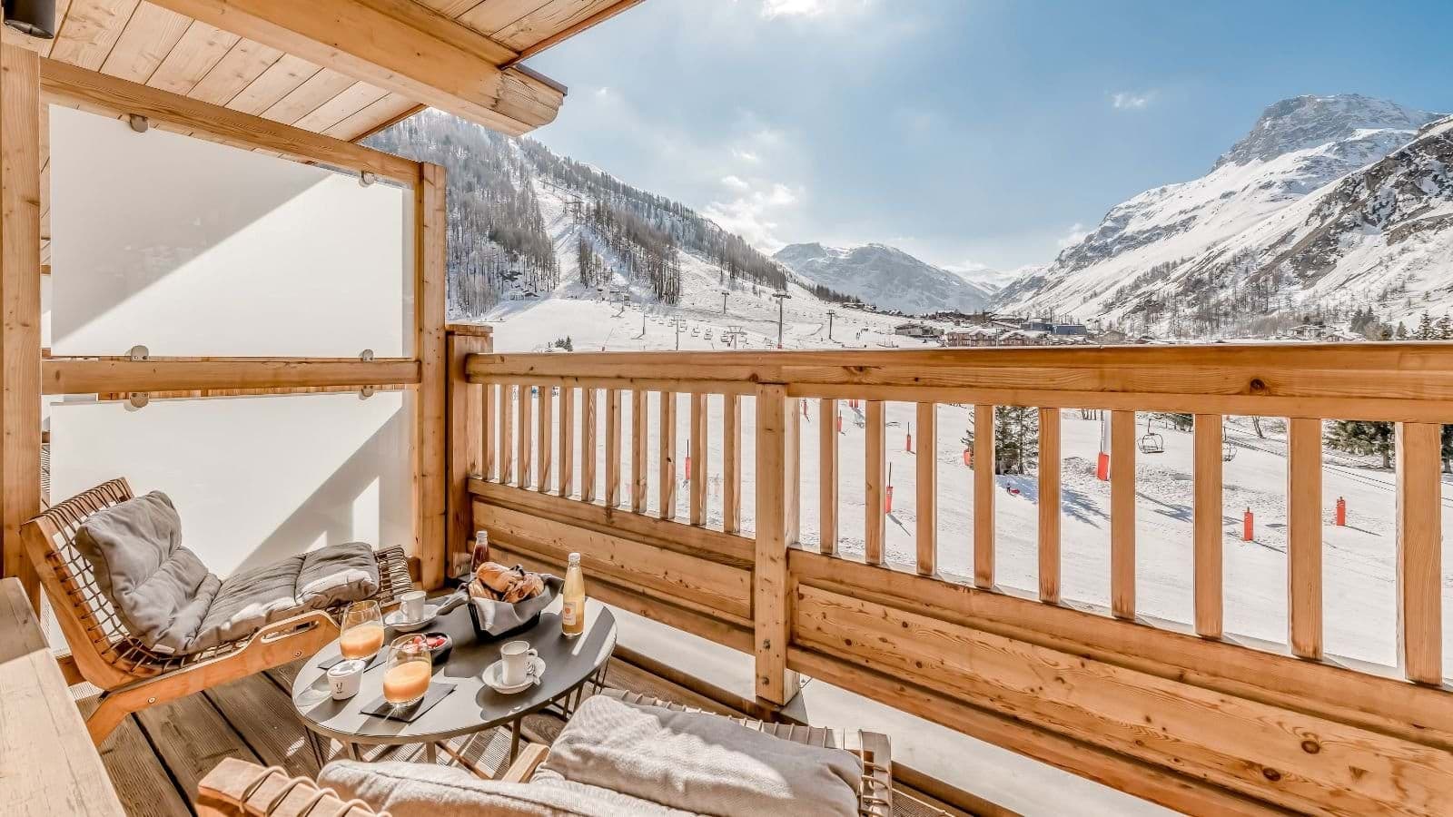 Private wooden balcony with seating and direct views of ski slopes