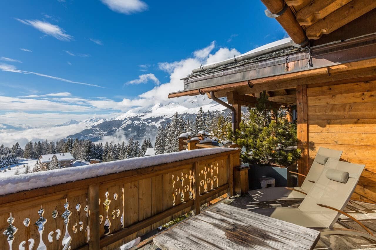 Private balcony with lounge seating and panoramic mountain views