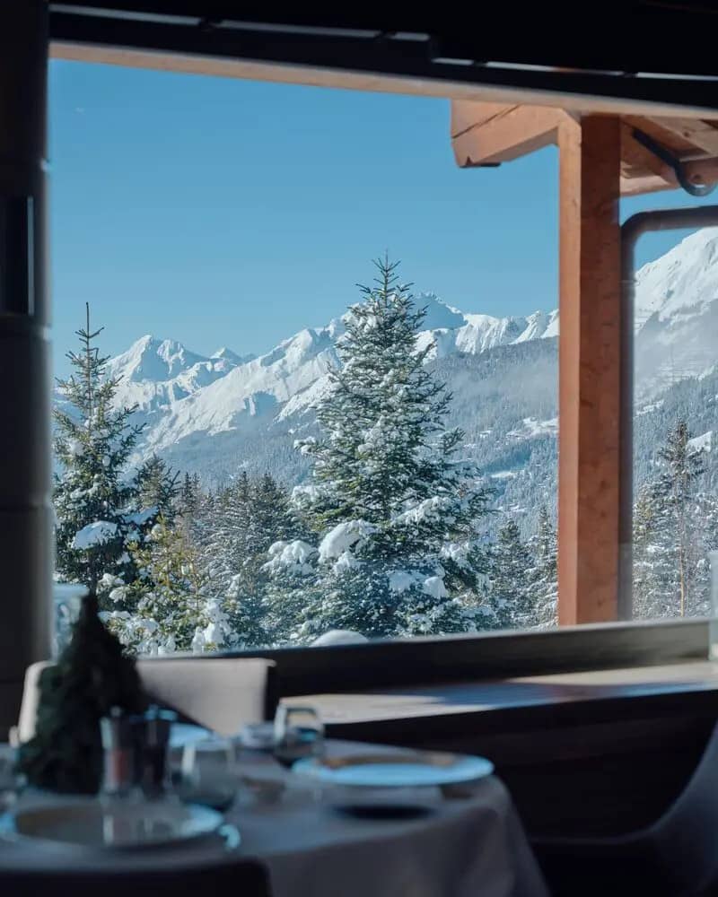 Dining area with panoramic mountain views and floor-to-ceiling windows