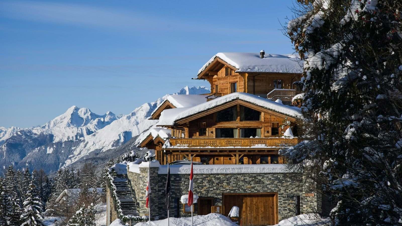 Ski-in/ski-out chalet exterior with heated driveway and panoramic mountain views