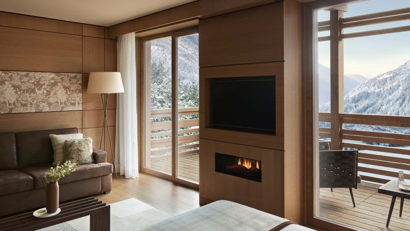 Seating area with gas fireplace and private balcony mountain views