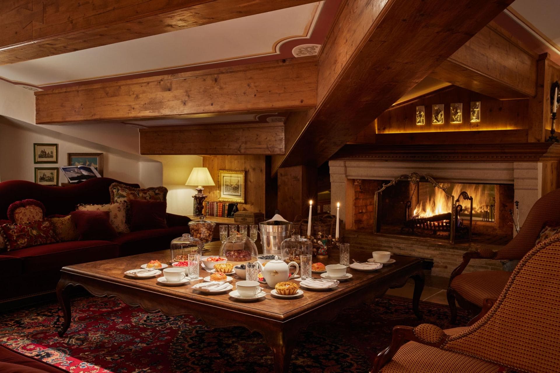 Living area with wood-burning fireplace and exposed timber beams