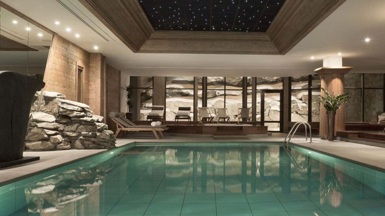 Indoor pool with fiber optic star ceiling and poolside loungers