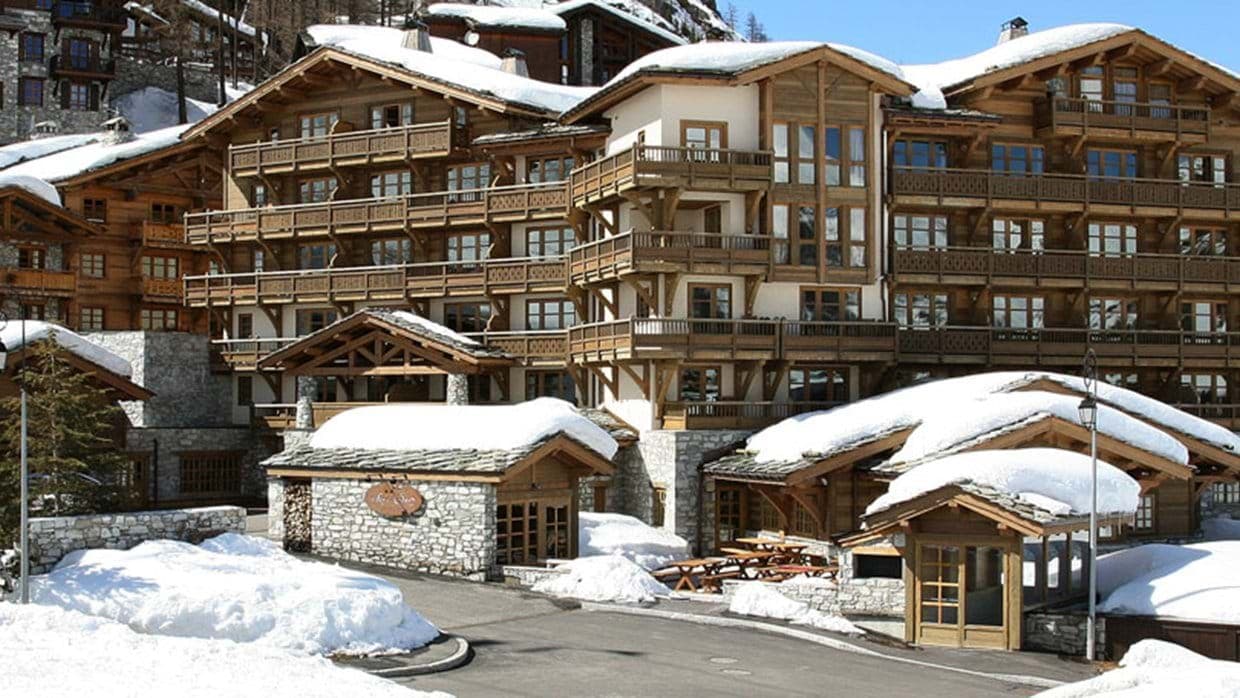 Alpine chalet featuring private wooden balconies and outdoor picnic seating
