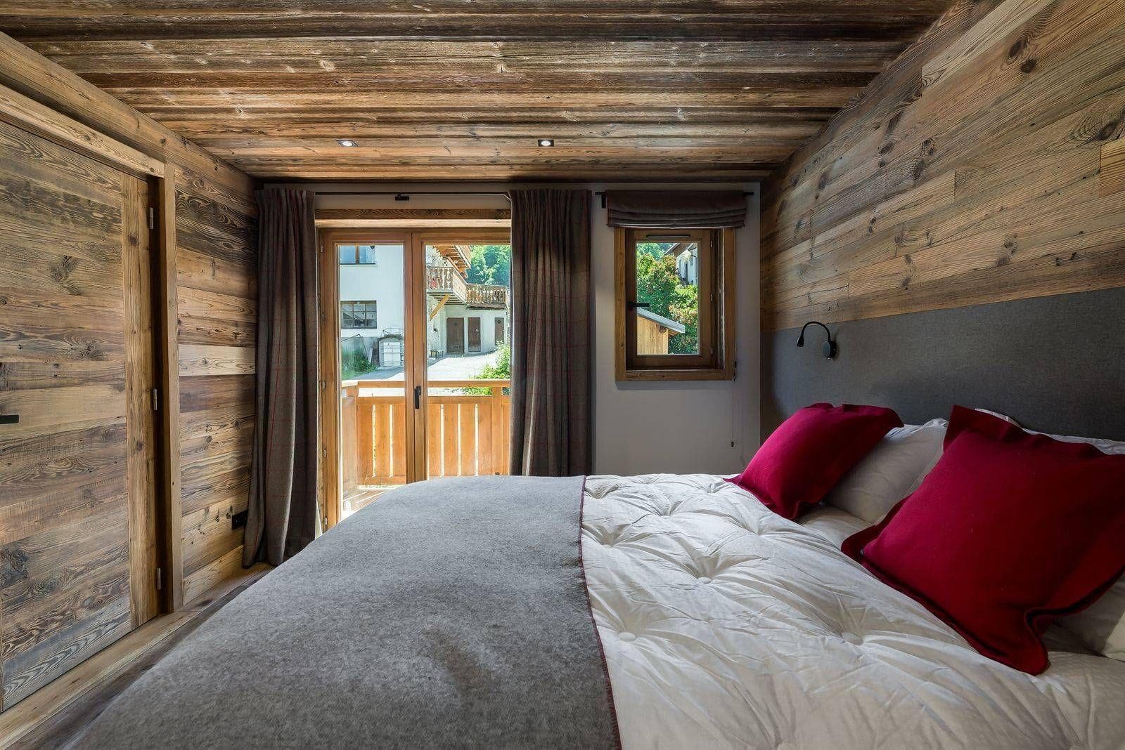 Double bedroom with terrace doors and timber wall panels