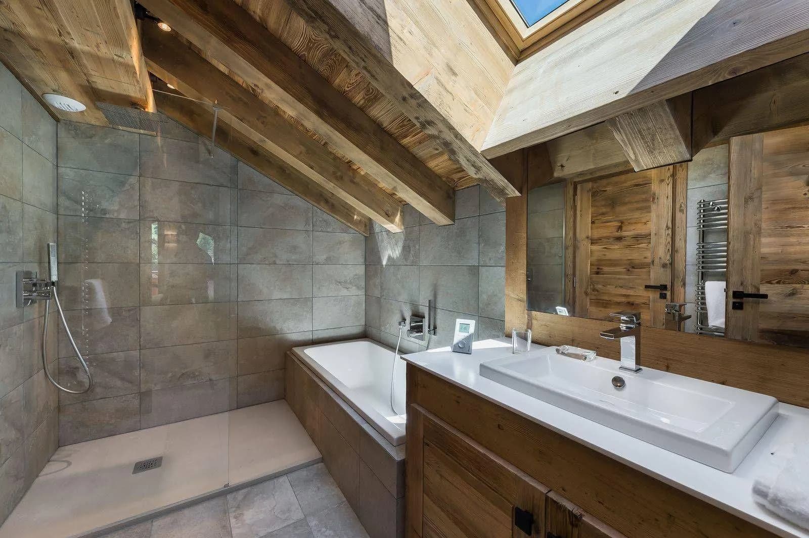 Bathroom with bathtub and basin beneath timber beams