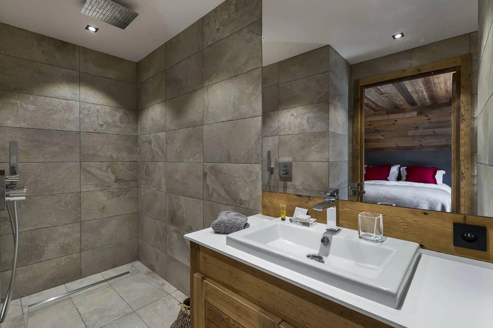 Bathroom vanity counter with twin basins and broad mirror