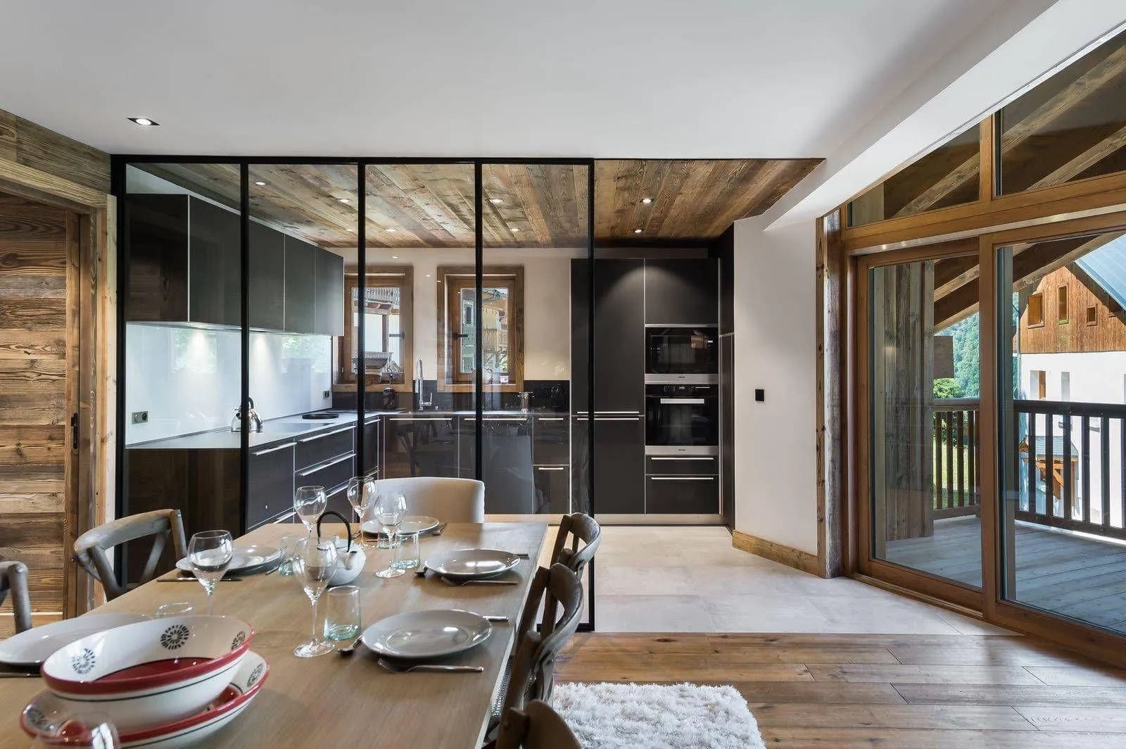 Dining table beside the glazed kitchen partition