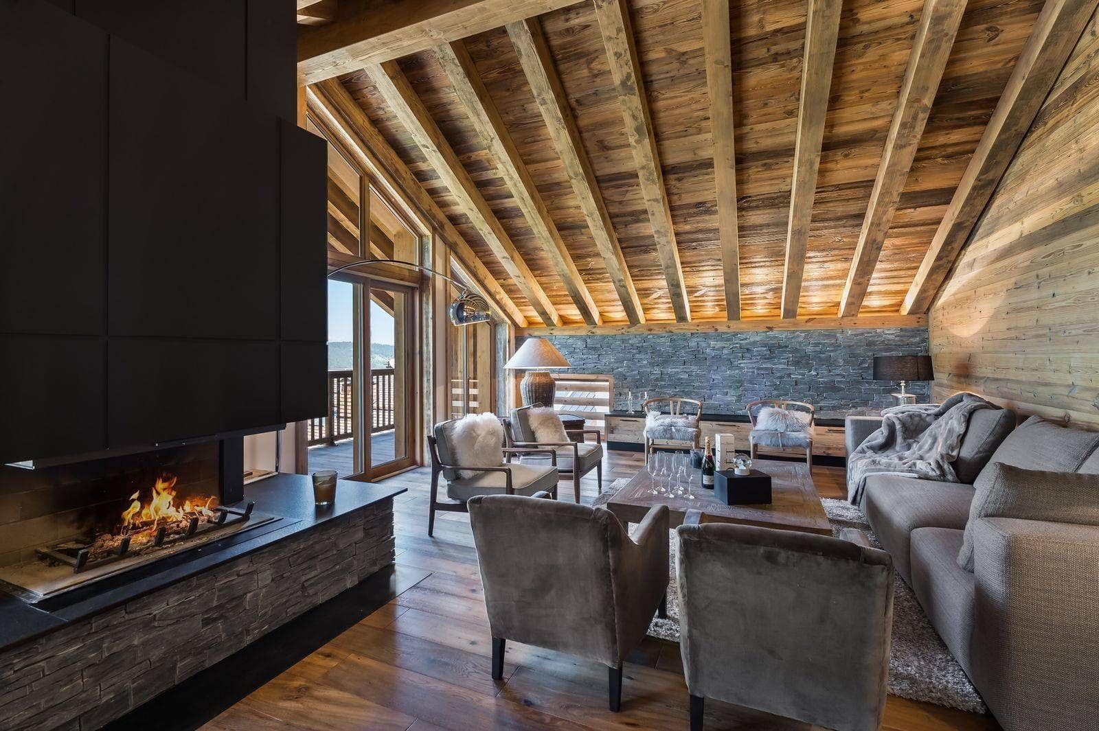 Living room beside central fireplace and balcony windows