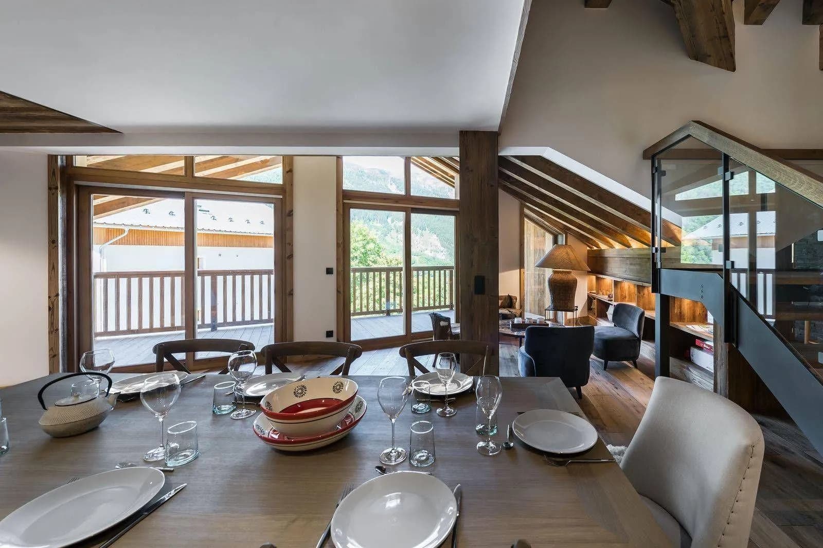 Dining room with mountain-facing windows and balcony doors