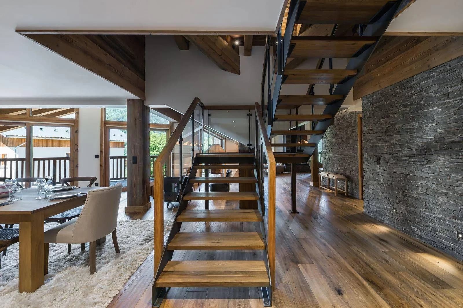 Interior staircase beside dining area and glazed balustrade