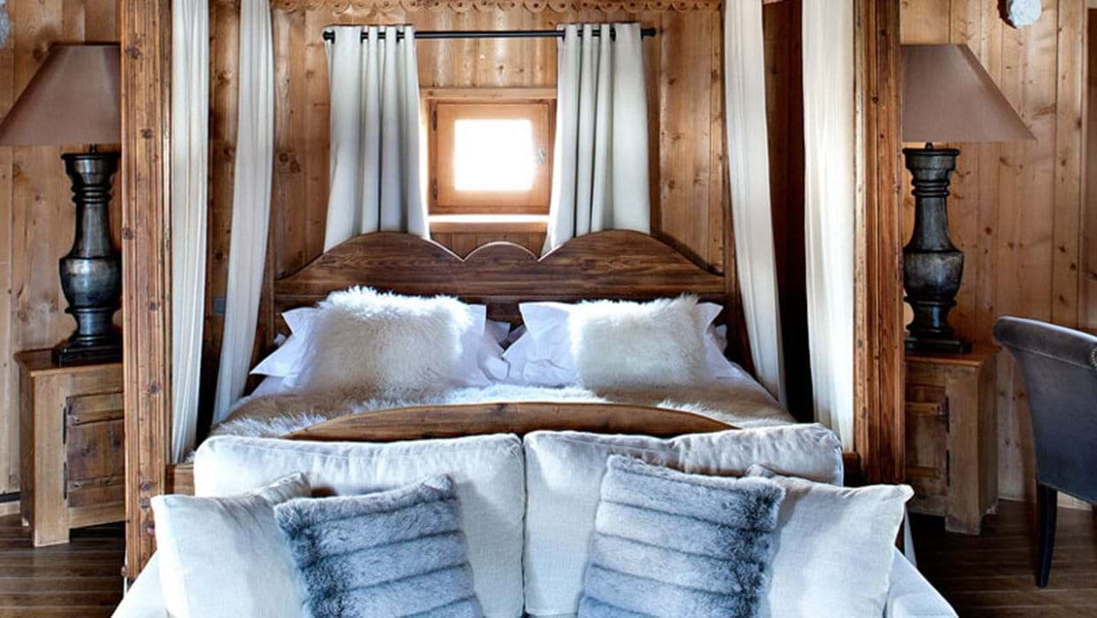Primary bedroom with four-poster king bed and reclaimed wood paneling