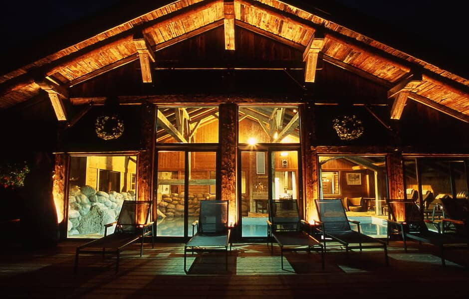 Pool deck with five sun loungers and views of the indoor heated pool