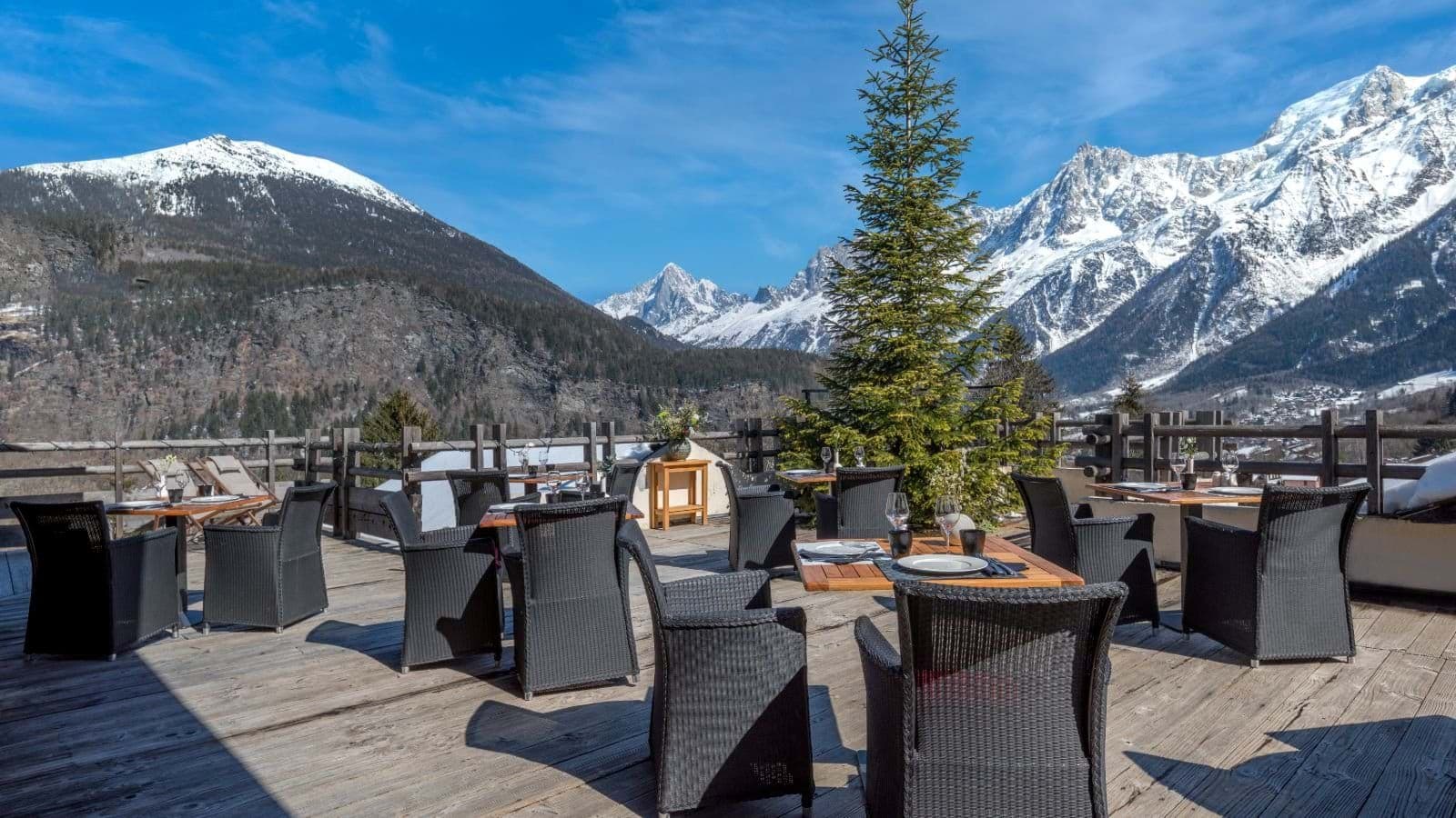 Outdoor dining terrace with panoramic views of the Alps
