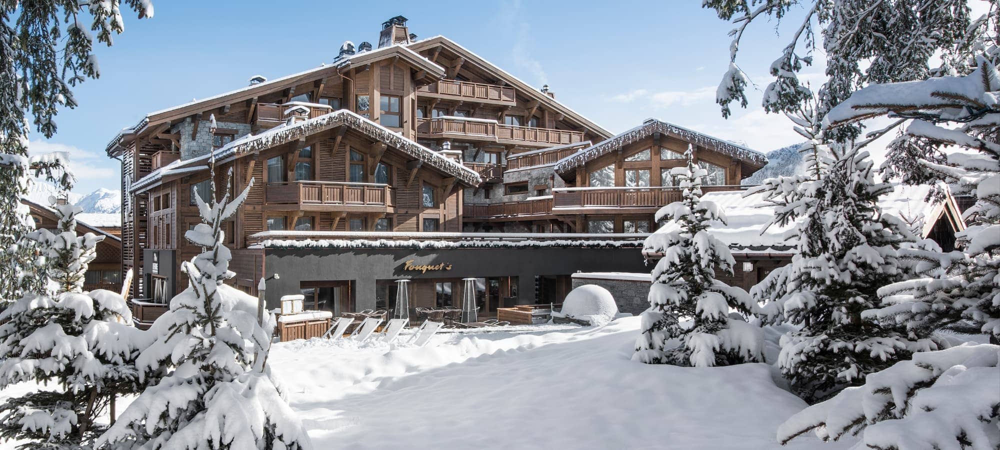 Multi-level timber lodge with private balconies and on-site restaurant terrace