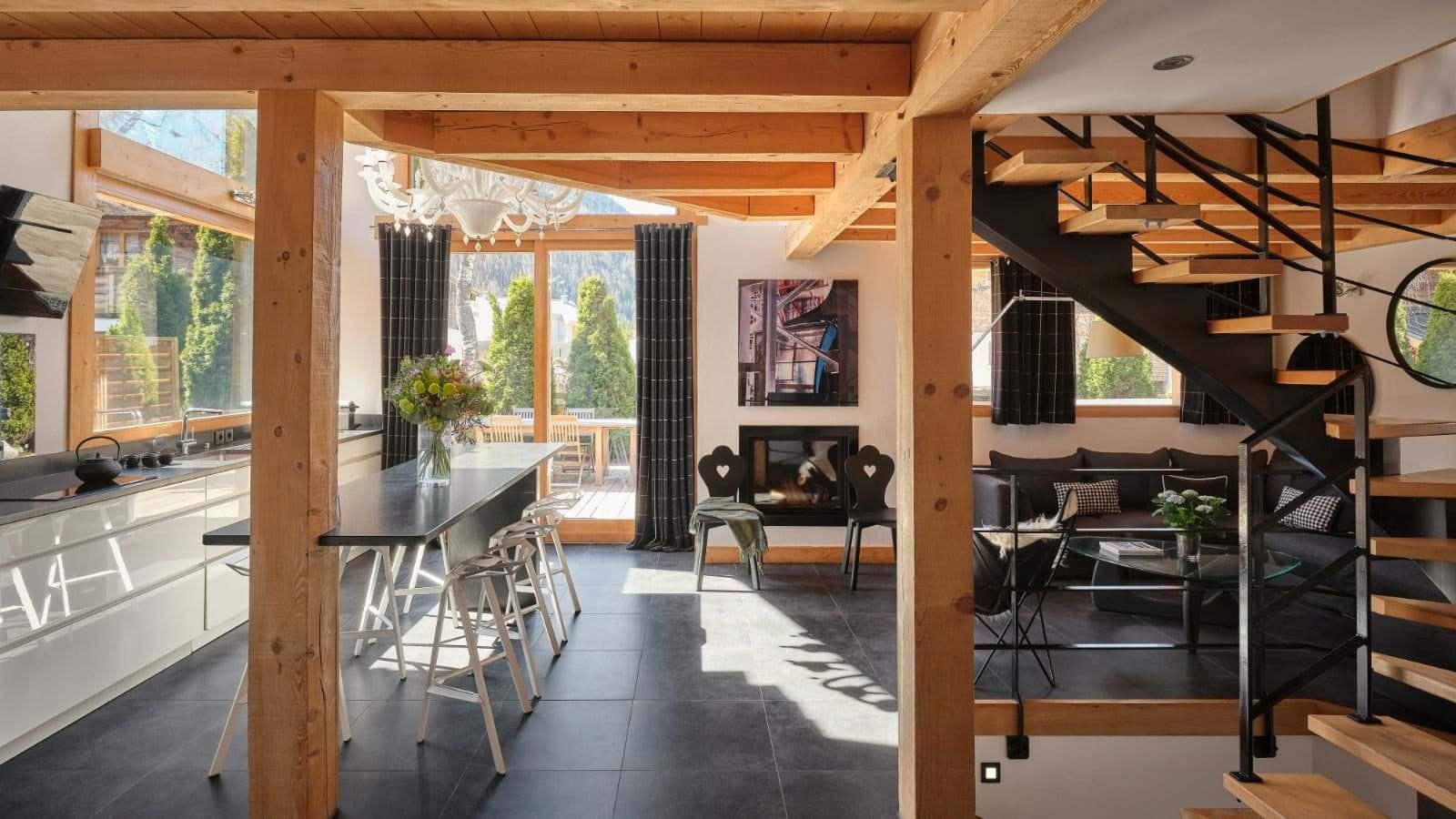 Open-plan kitchen and living area with island seating and terrace access