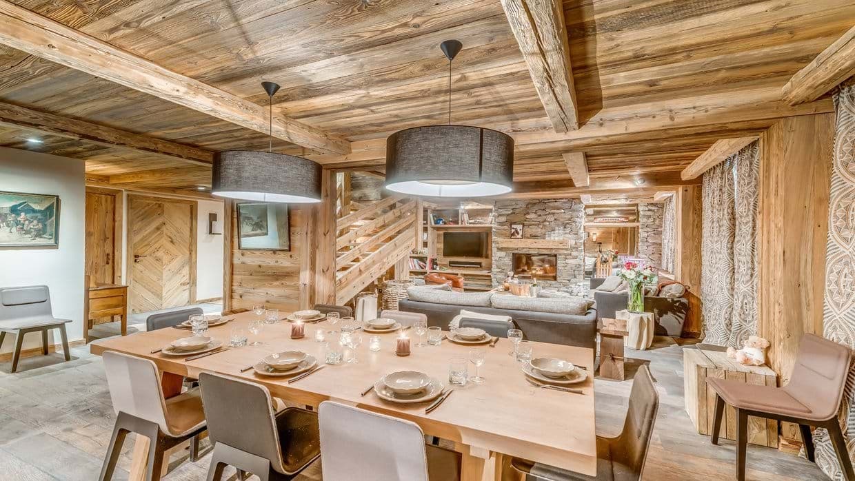 Dining area seats 10; open-plan layout with stone fireplace