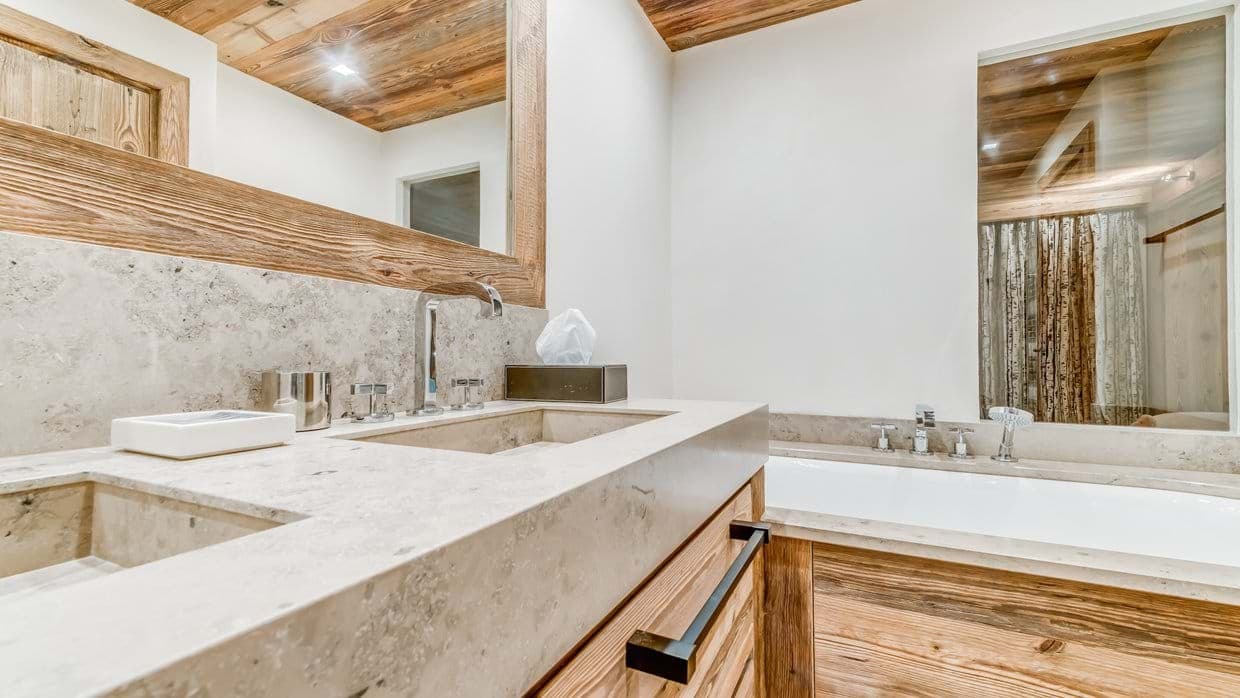Dual vanity with stone countertops and soaking tub