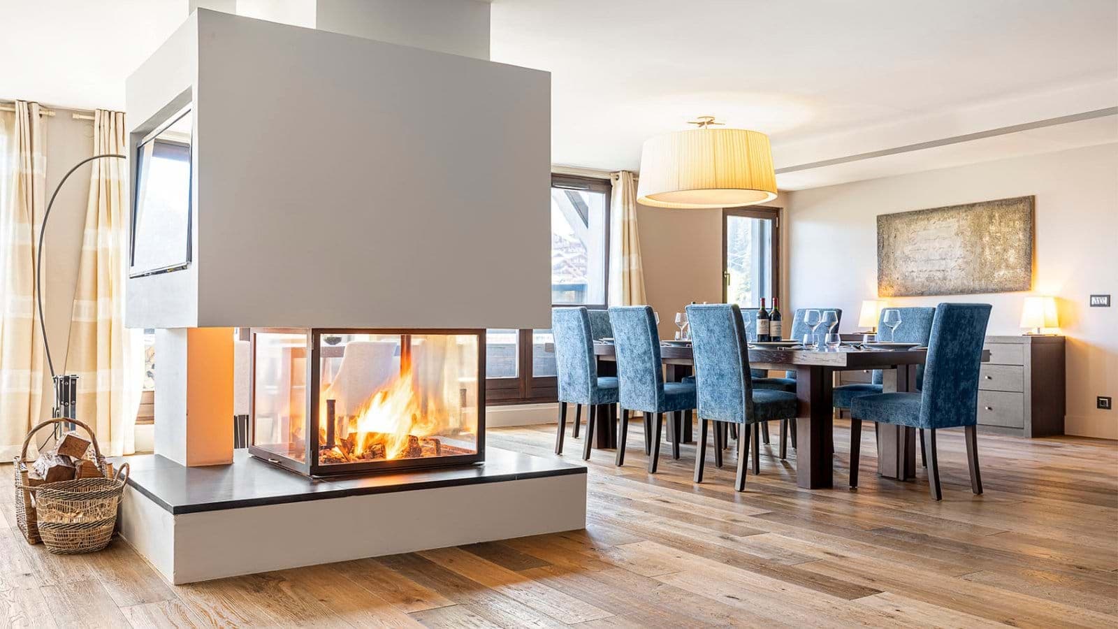 Open dining area with three-sided glass fireplace and seating for 8