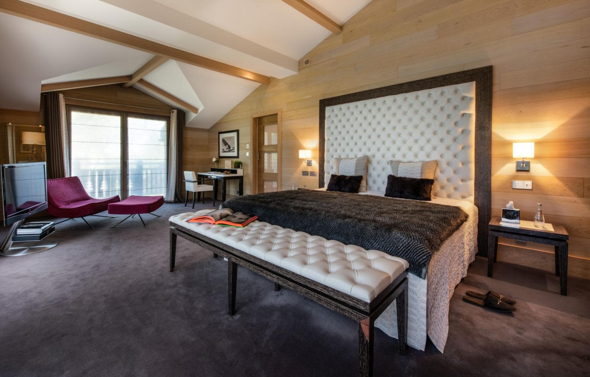 Primary bedroom with king bed and balcony access