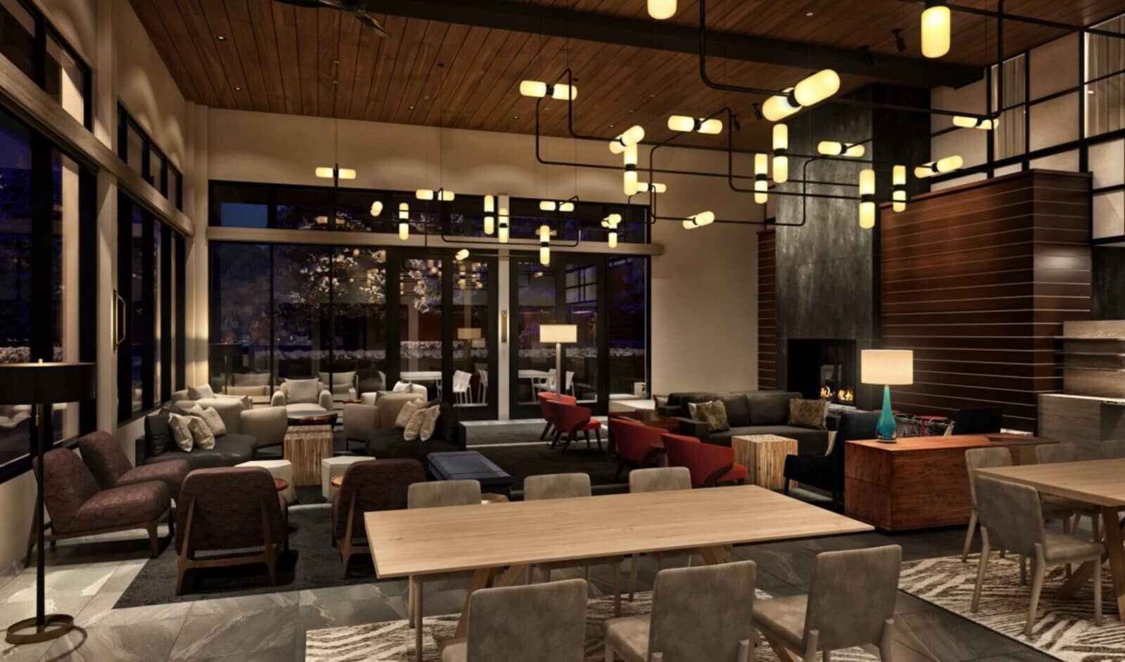 Shared lounge with multiple seating clusters, fireplace, and floor-to-ceiling windows