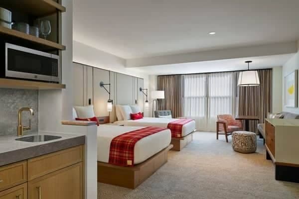 Guest suite with two queen beds and kitchenette featuring microwave and sink