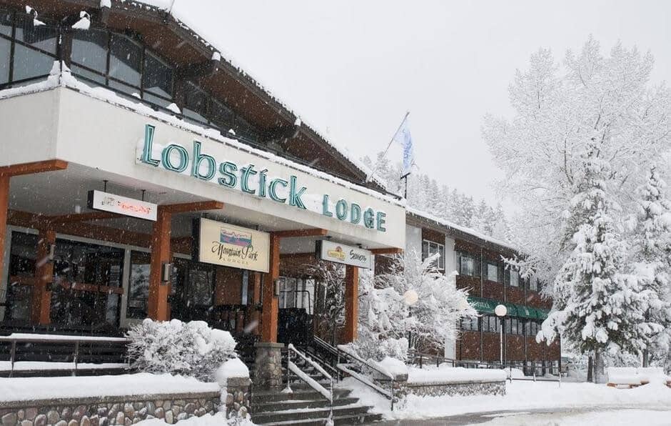 Lobstick Lodge main entrance with covered walkway and on-site restaurant signage