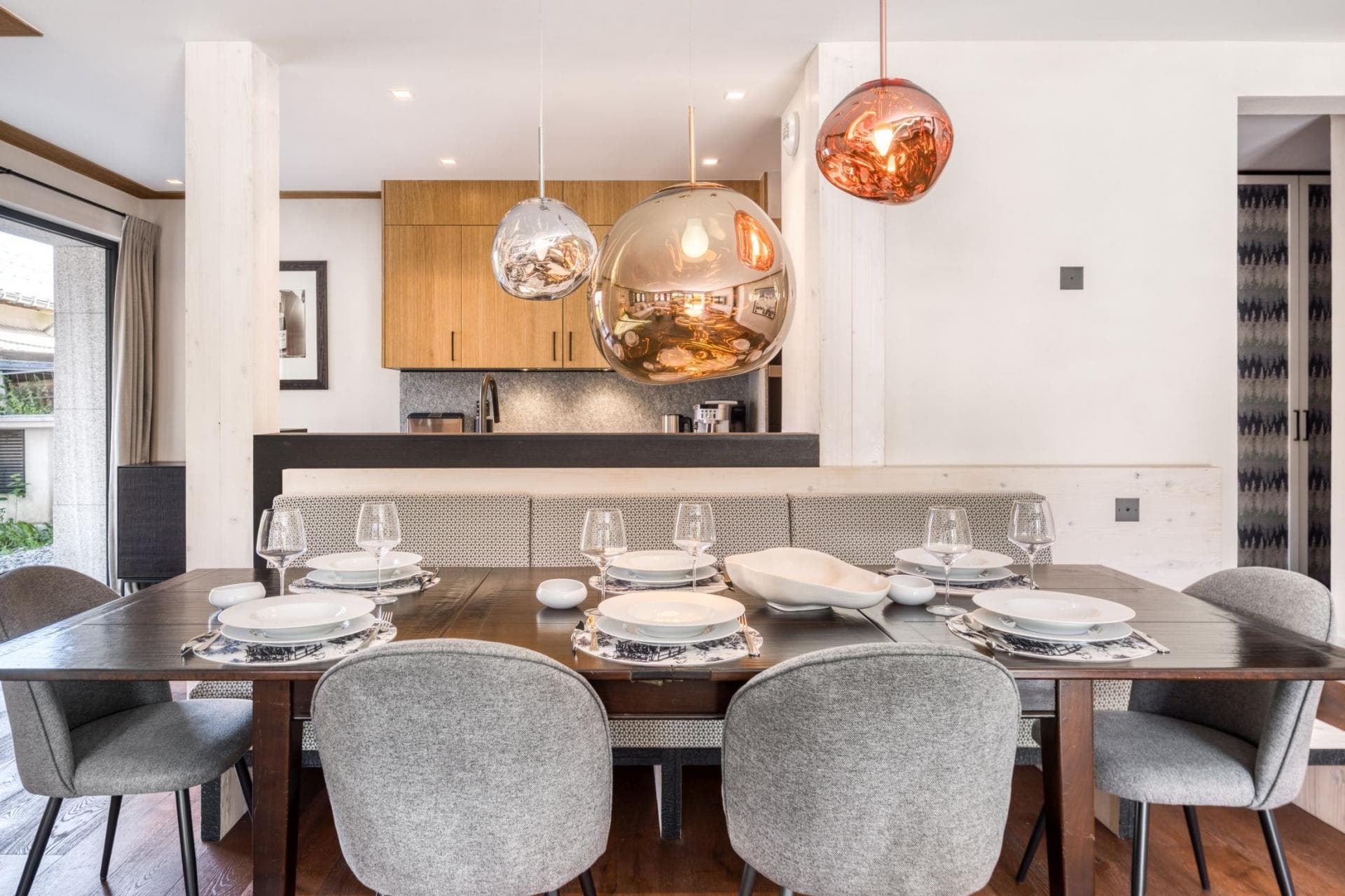 Dining area with banquette seating and view into the kitchen