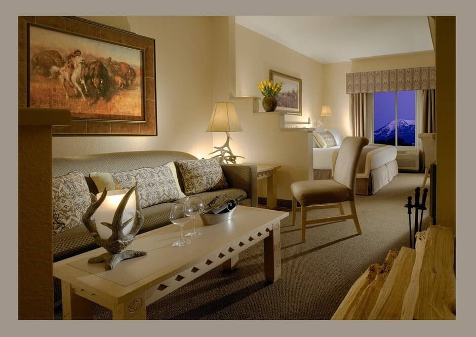 Primary bedroom with king bed and snow-capped mountain views through corner windows