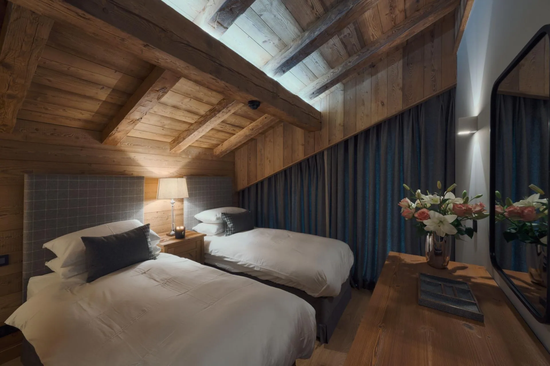 Guest bedroom with two twin beds and exposed timber vaulted ceiling