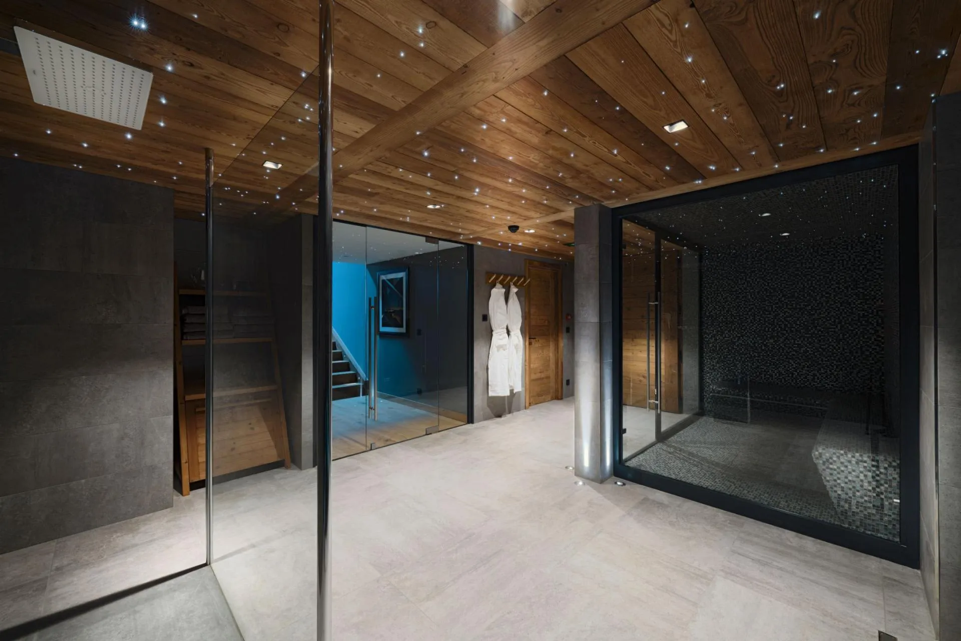 Spa area with walk-in rainfall shower and tiled steam room