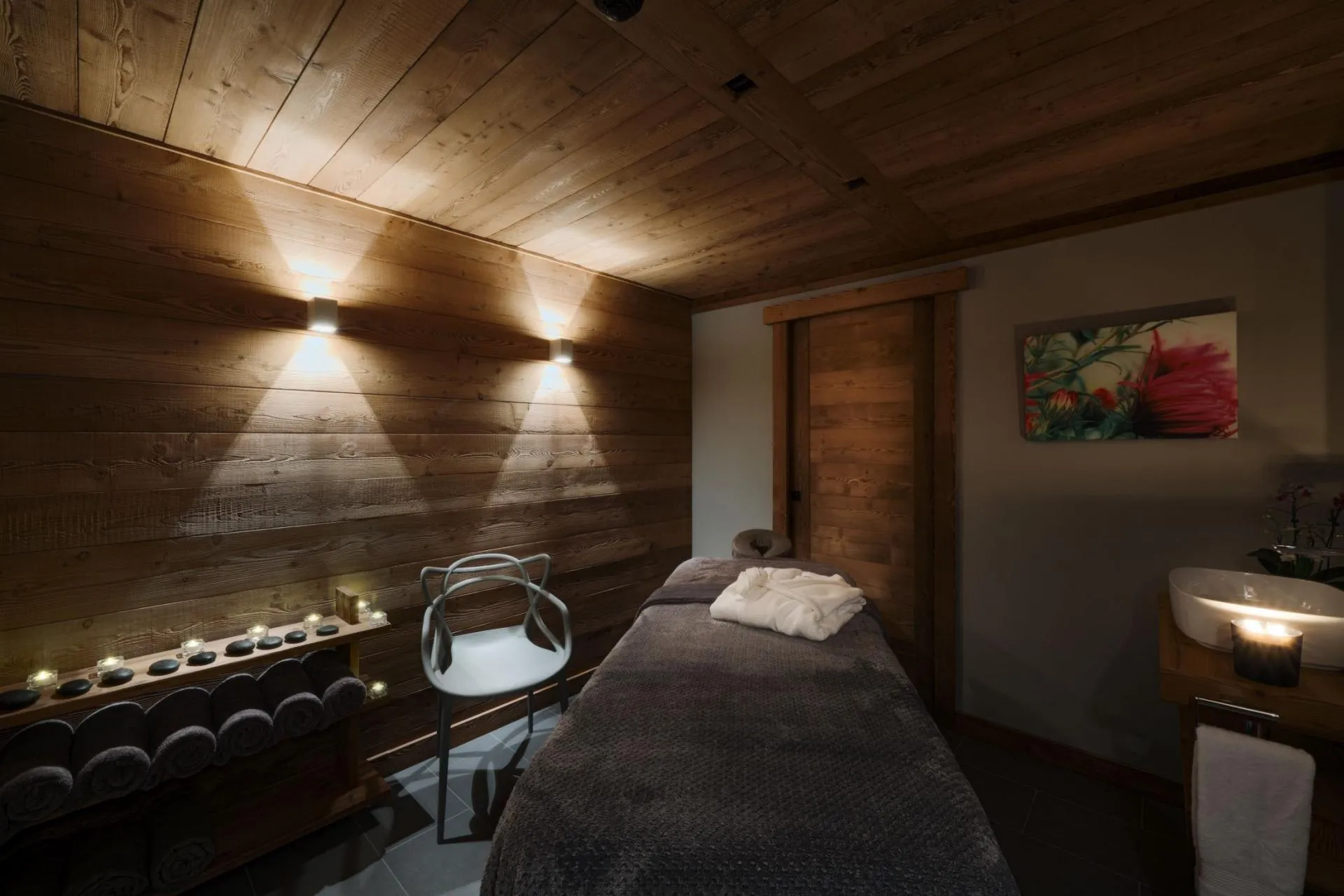 Private massage room with treatment table and sink