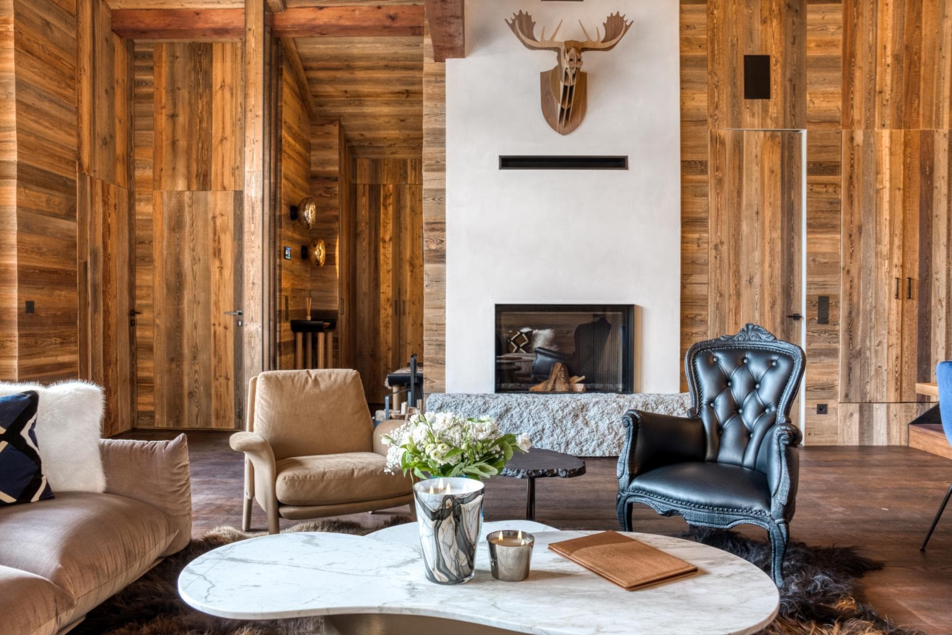 Living area with wood-paneled walls and wood-burning fireplace