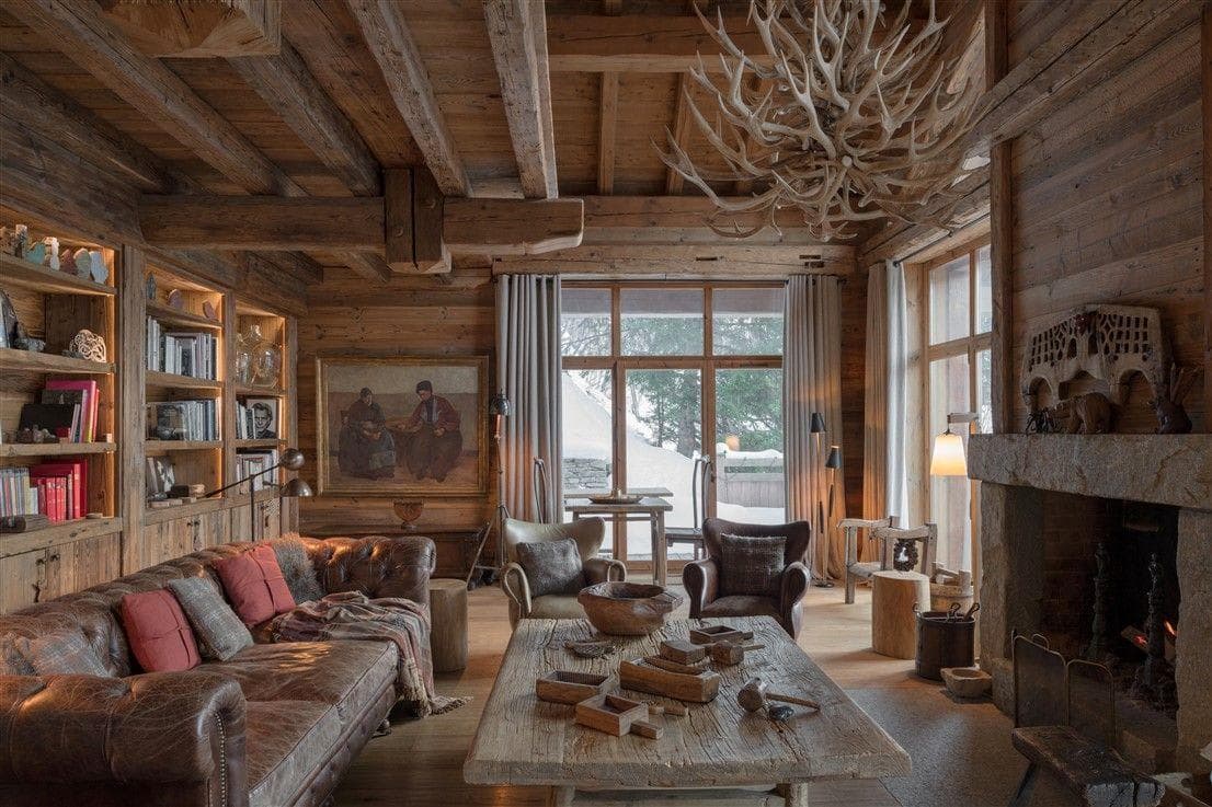 Living room with stone fireplace and built-in library shelving