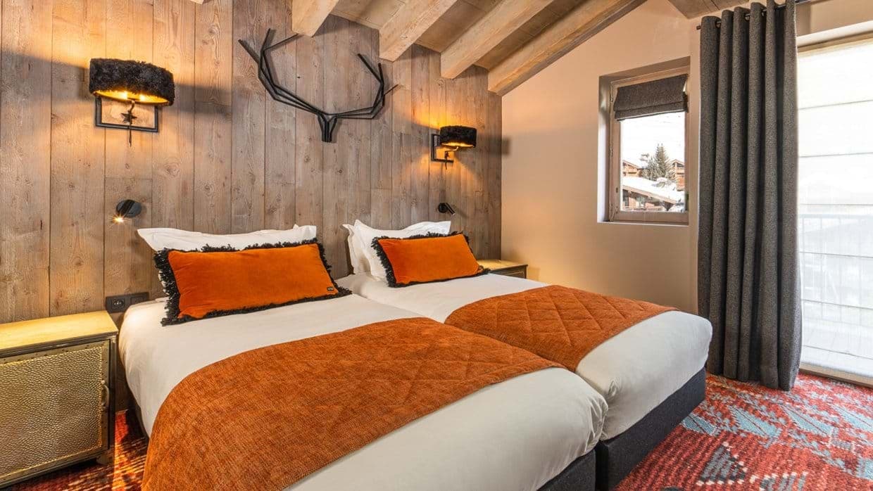 Bedroom with twin beds and mountain village views