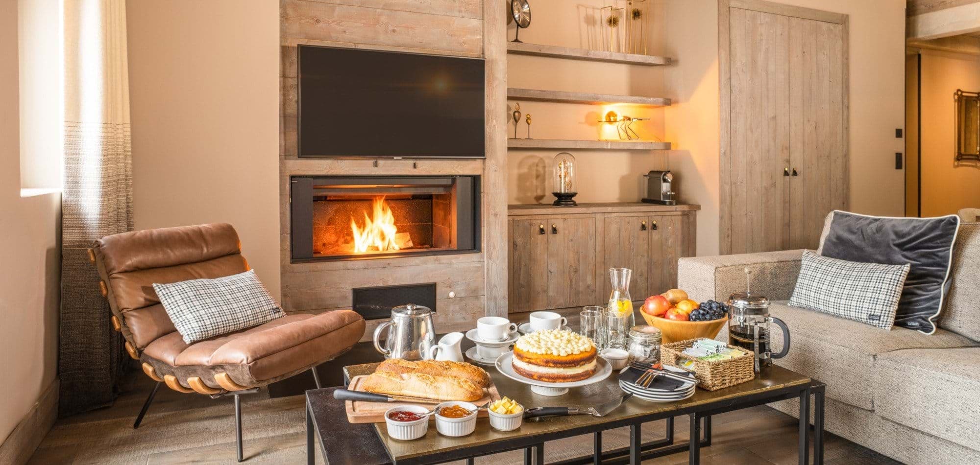 Living area with wood-burning fireplace, smart TV, and Nespresso machine