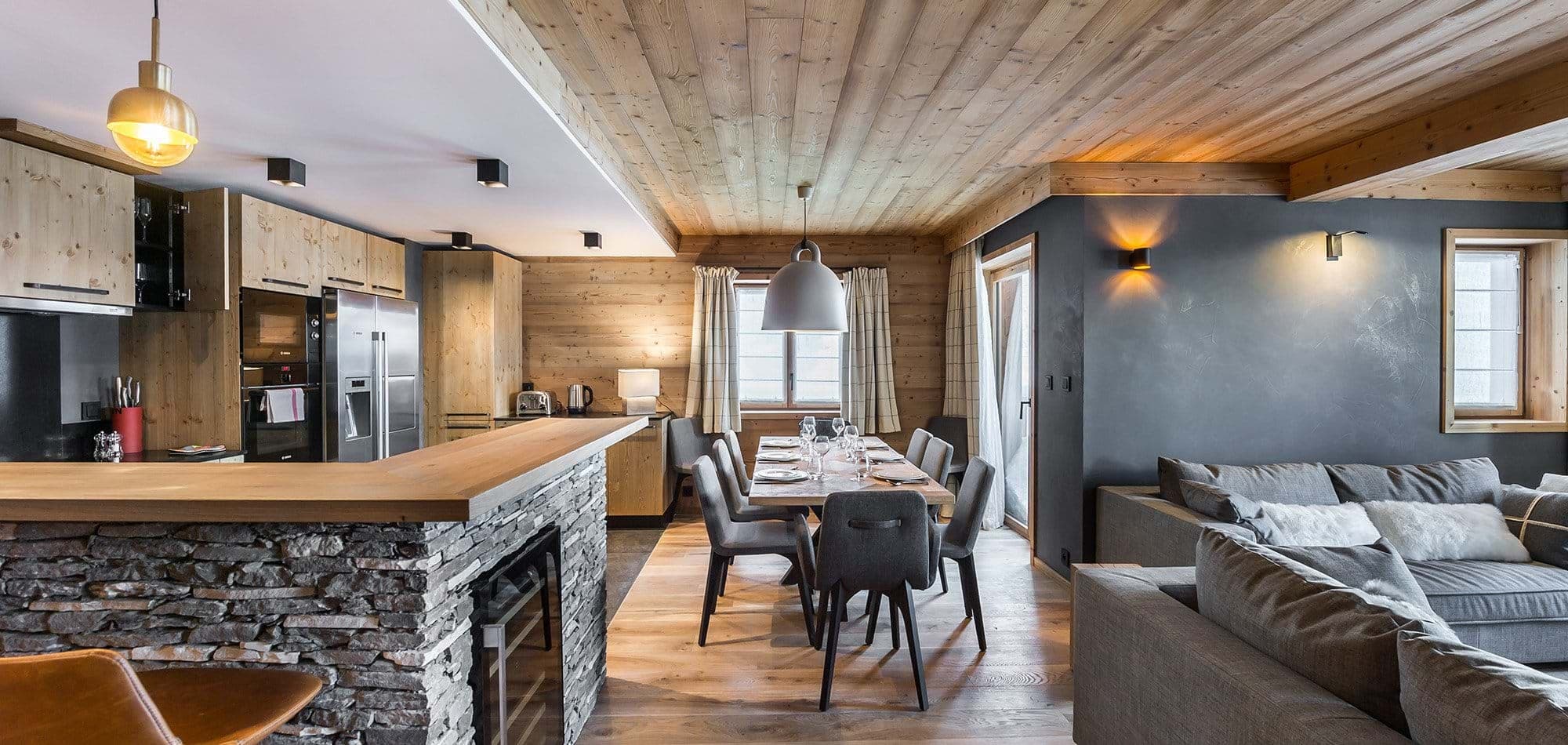 Open-plan living area with 8-seat dining table and stone breakfast bar