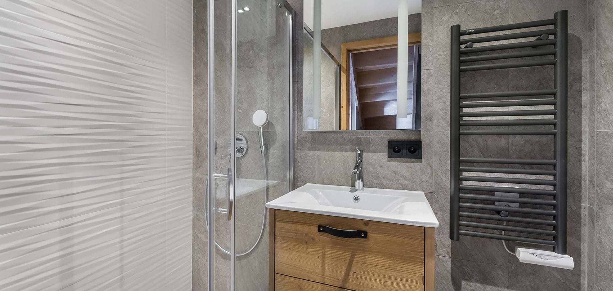 Bathroom featuring glass walk-in shower and heated towel rail
