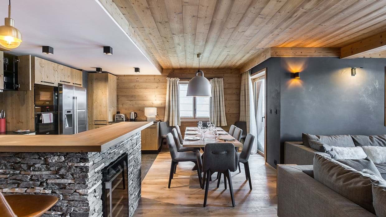 Open-plan living area featuring stone breakfast bar with built-in wine fridge