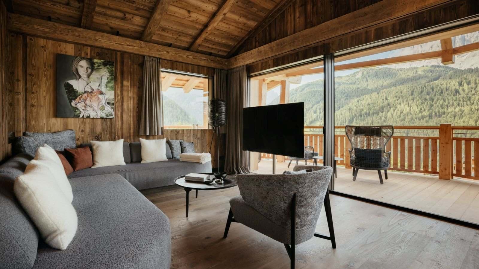Living area with floor-to-ceiling glass doors and mountain valley views