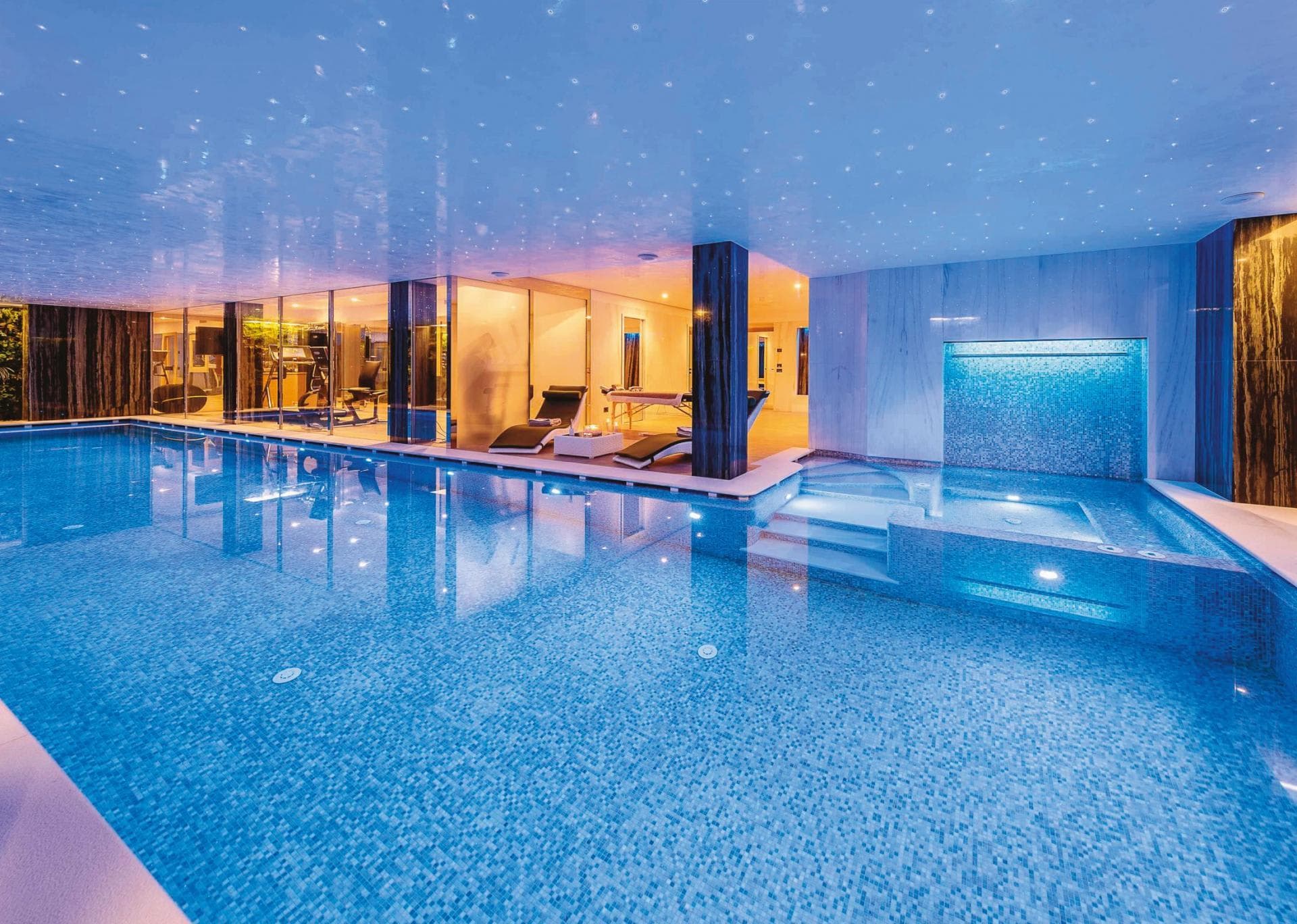 Indoor pool and hot tub featuring fiber optic starlight ceiling