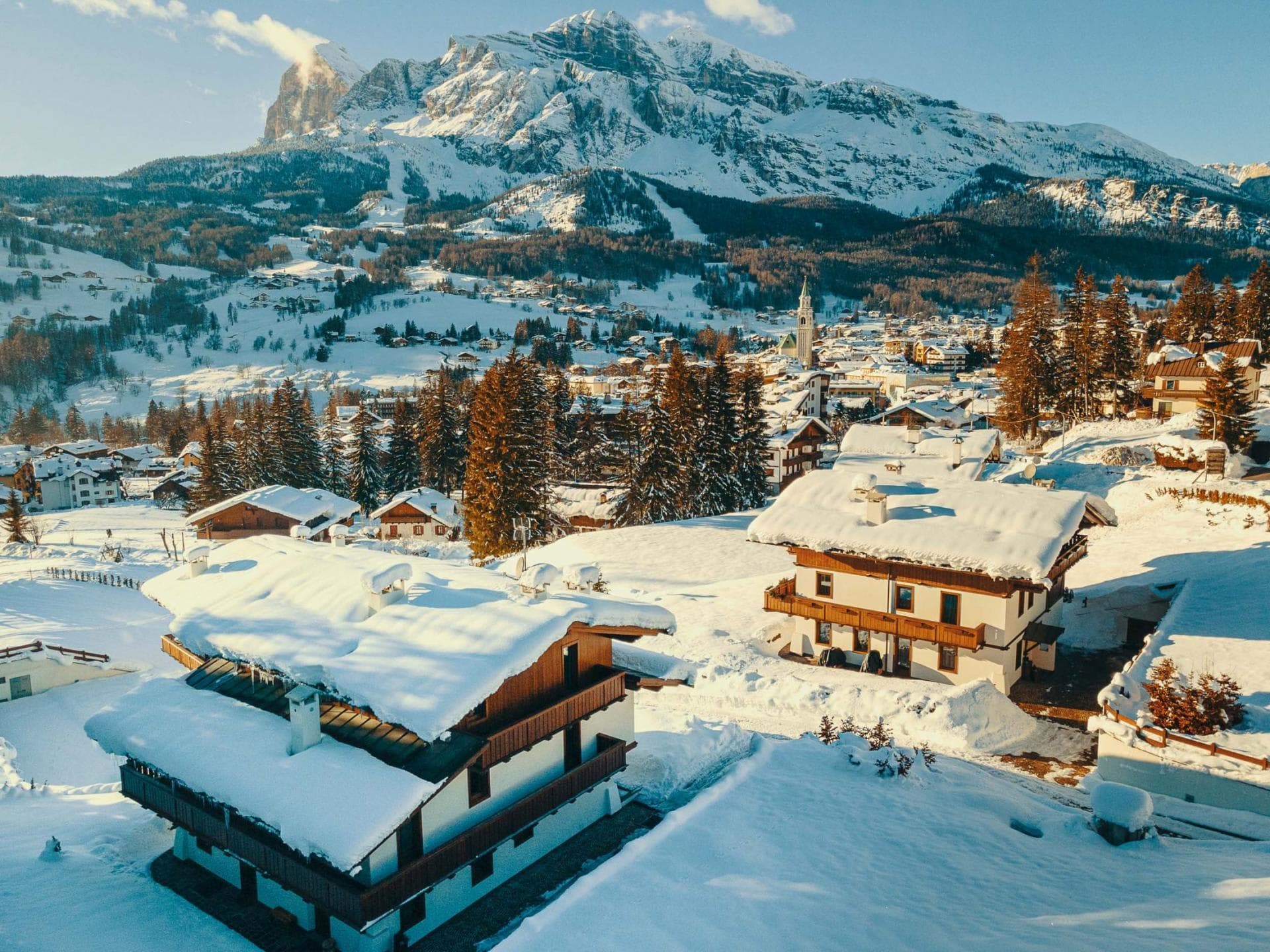 Aerial view of chalet exterior with Dolomite mountain backdrop