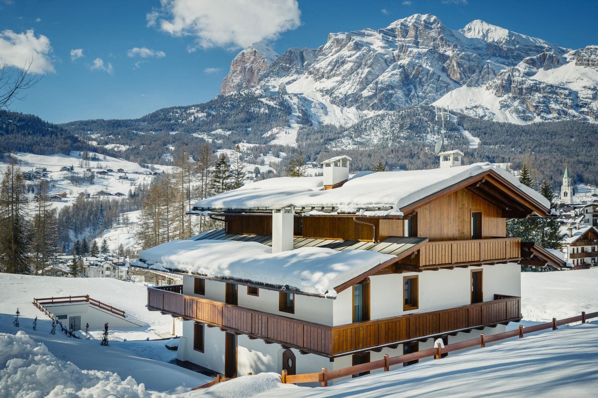 Chalet exterior with wrap-around balconies and Tofane mountain views