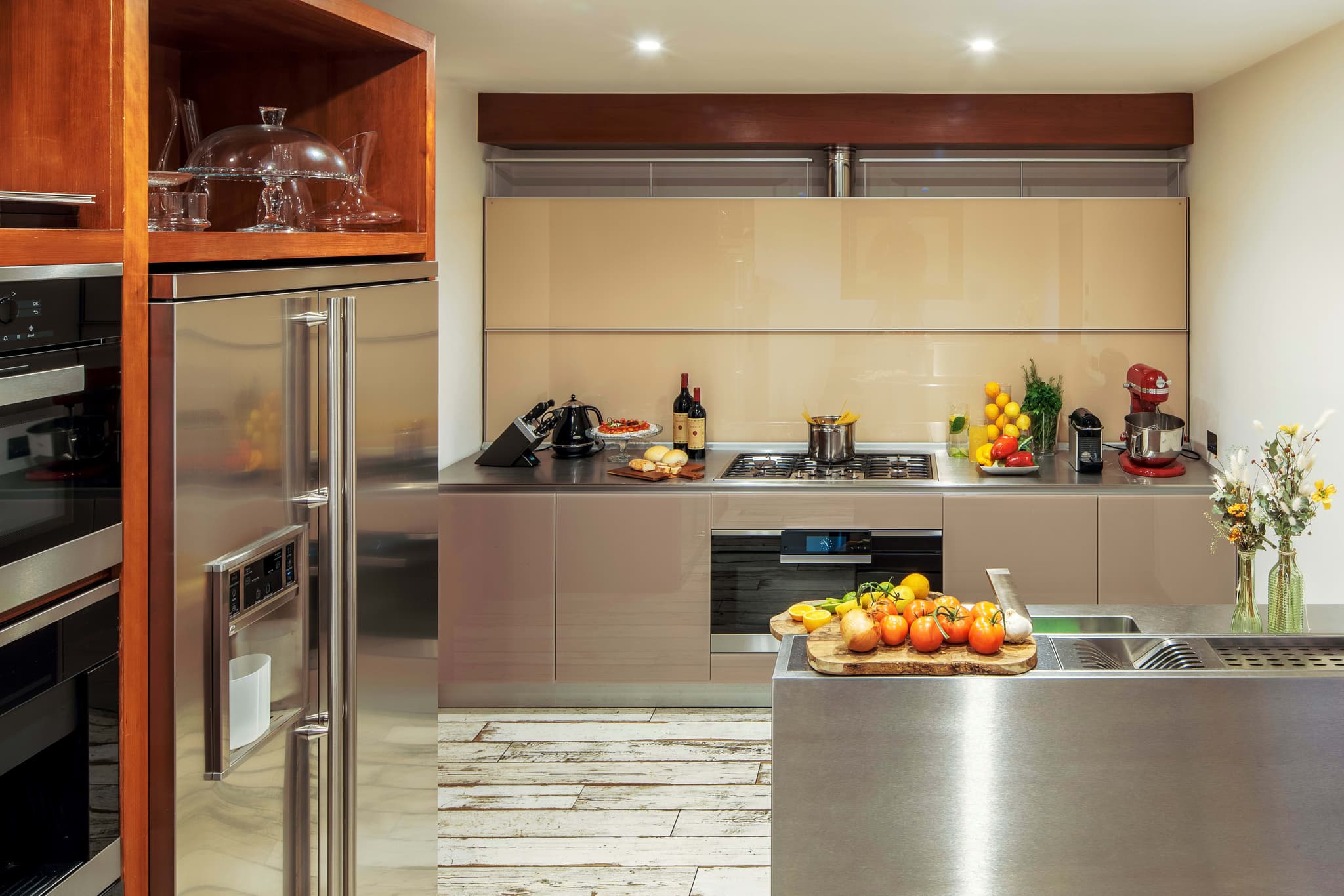 Kitchen with stainless steel counters, gas range, and KitchenAid stand mixer