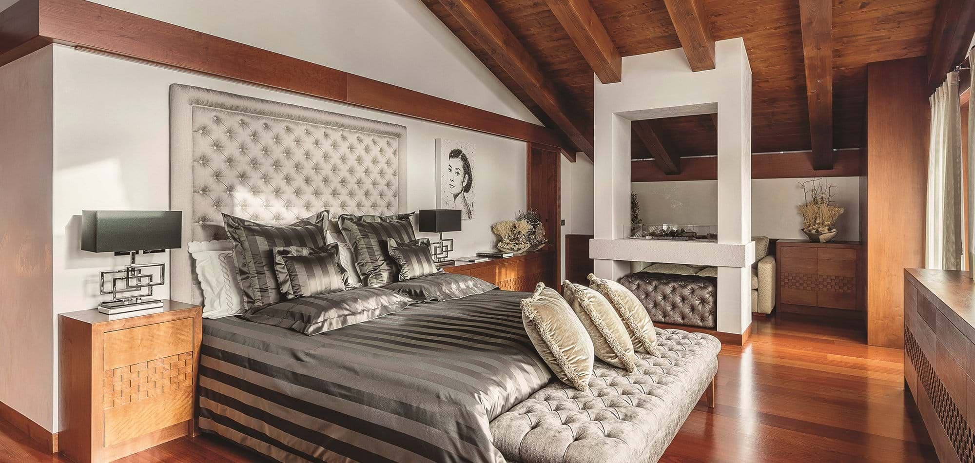 Primary bedroom with king bed and double-sided fireplace