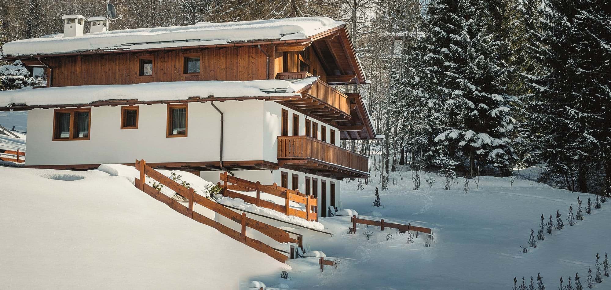 Ski-in chalet exterior with multi-level wrap-around balconies