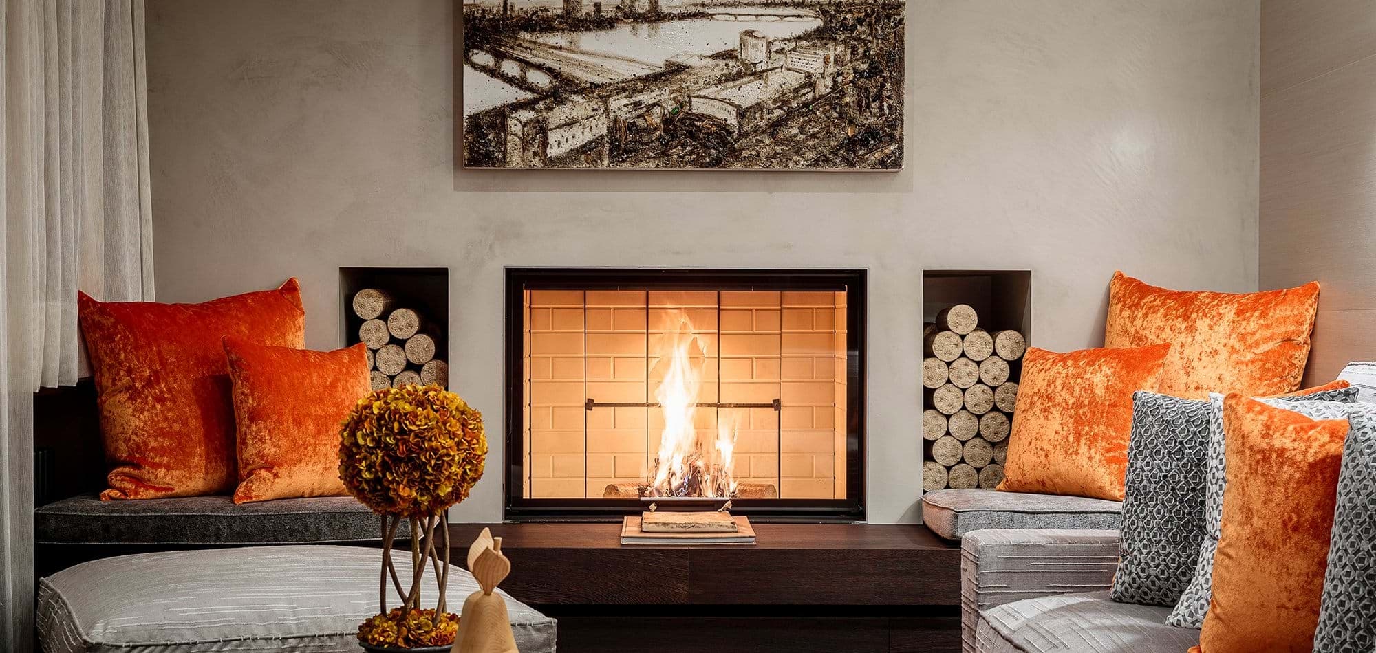 Wood-burning fireplace with built-in firewood storage and cushioned bench seating