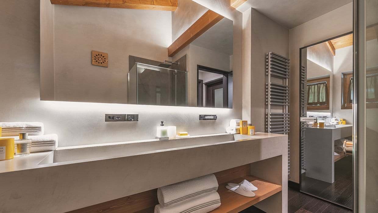 Bathroom featuring extra-wide trough sink and wall-mounted towel heater