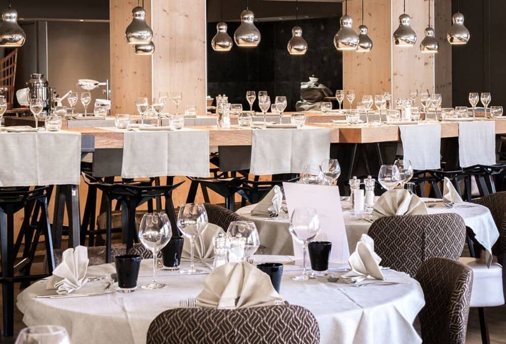 Dining area featuring communal high-top tables and round seating for large groups